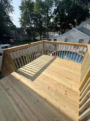 Newly built wooden deck with pressure-treated boards and railings, ready for spa placement