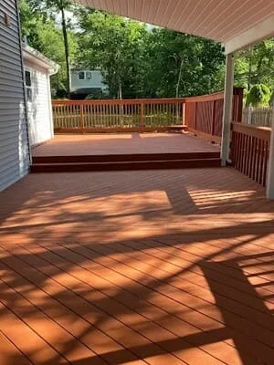 Composite deck with railings and covered pavilion, warm wood tones